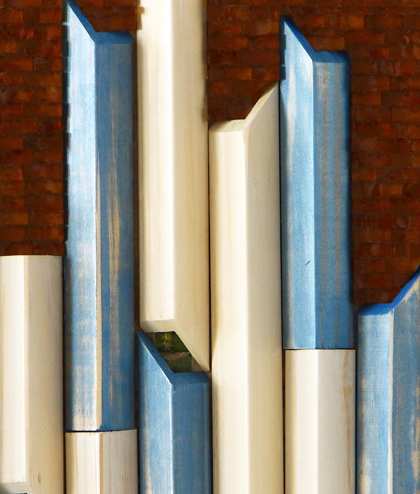 Close up detail of Structure, 12 x 16, mixed media artwork showing amber glass mosaic and sky blue and cream stain washed outside corner moulding