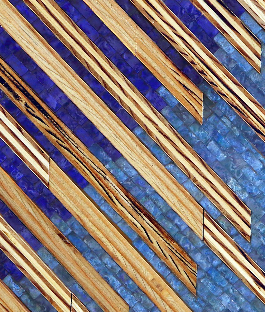 Photo of close up detail of What’s Your Slant, 1st Edition, 12x 16, mixed media mosaic interior wall art made from cobalt and ocean blue glass mosaic tile and maple wood but into strips. Abstract style with an Asian flair.
