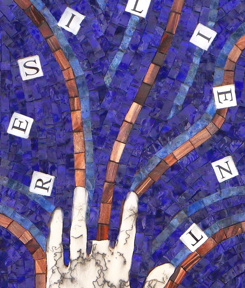 Close up detail of Caryn Mitchell’s, Resilient, 12 x 24, mixed media glass mosaic artwork showing cobalt blue glass mosaic background, scrabble letters and life-casted horse hair raku fired hand with blue and copper energy waves extending from the fingers.